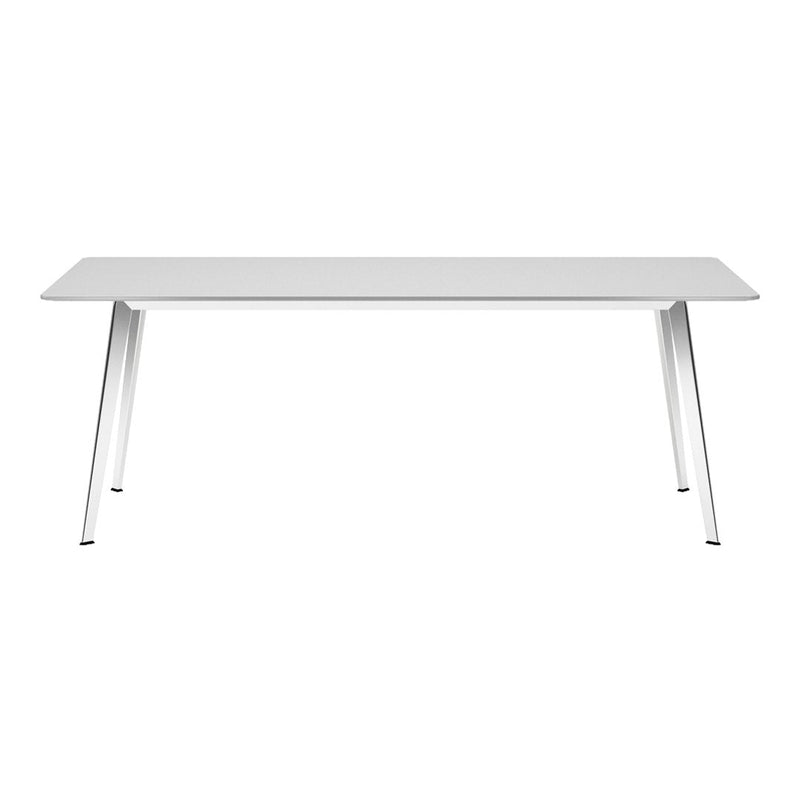 White dining table with sleek metal legs, featuring a minimalist design and smooth surface for modern decor.