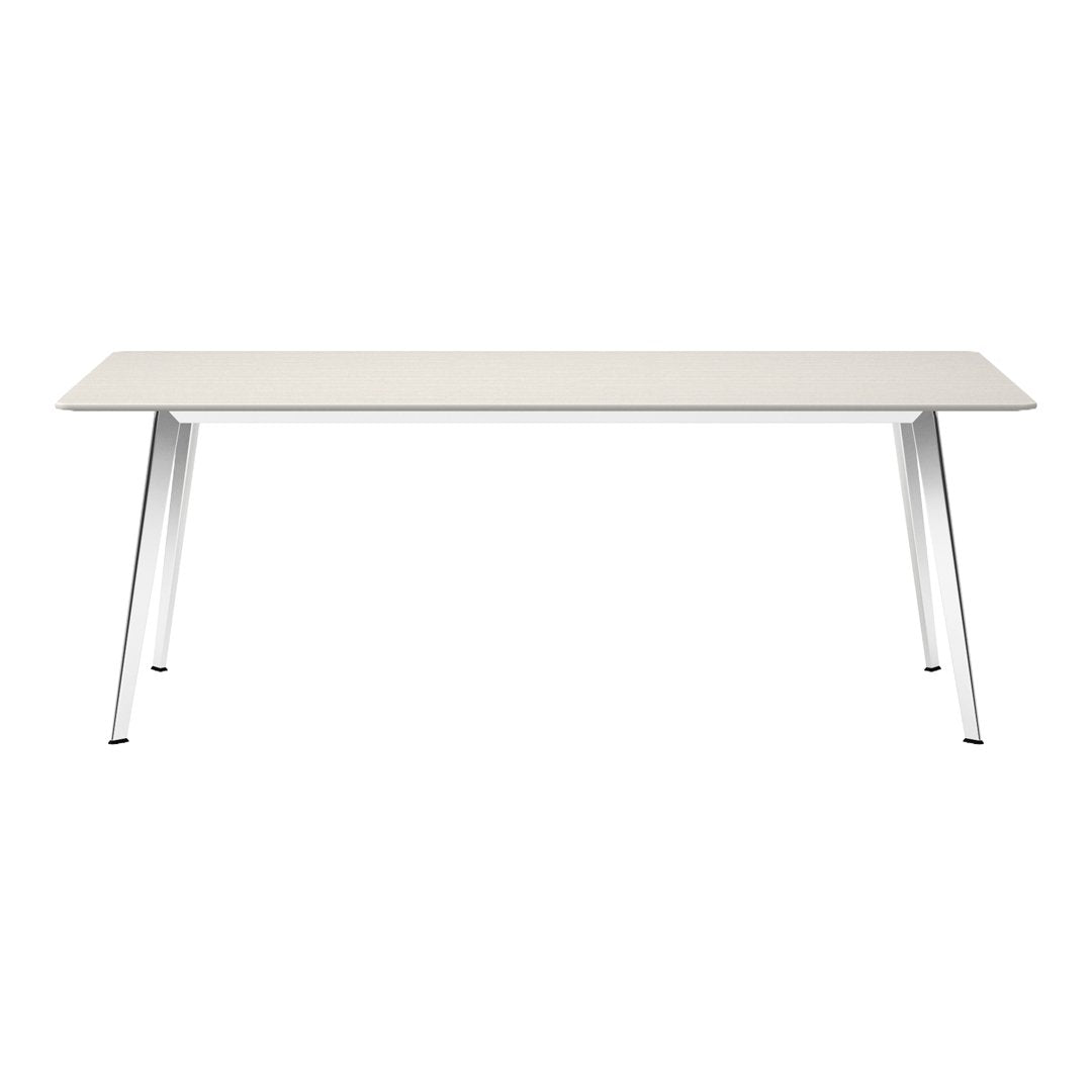 Modern white dining table with a textured light gray surface and sleek metallic legs, perfect for contemporary spaces.