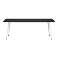 Modern black tabletop with sleek white legs, offering a minimalist design for any workspace or dining area.
