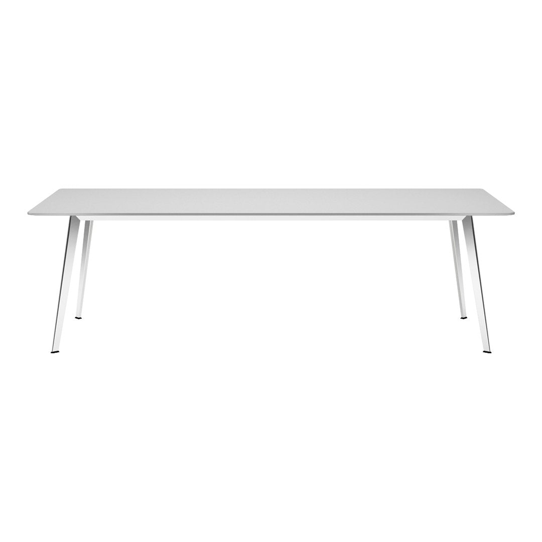 Modern white dining table with sleek silver legs, featuring a minimalistic design and smooth surface.