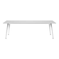 Modern white dining table with sleek silver legs, featuring a minimalistic design and smooth surface.