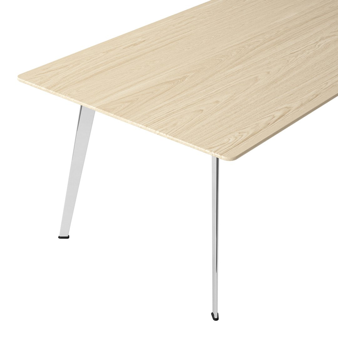 Light wood grain tabletop with smooth finish and chrome legs, offering a modern, minimalist aesthetic.