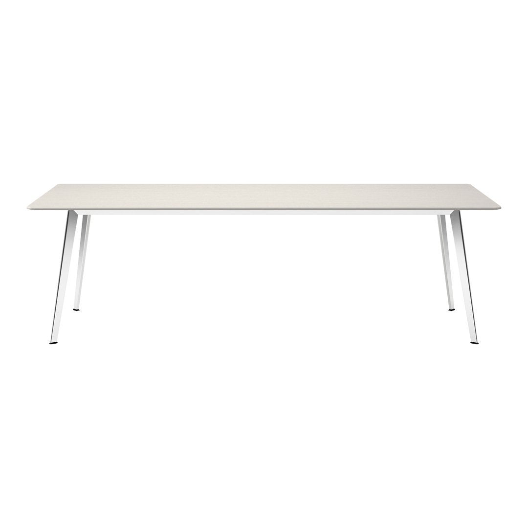 Minimalist white rectangular table with a textured surface and sleek silver legs.