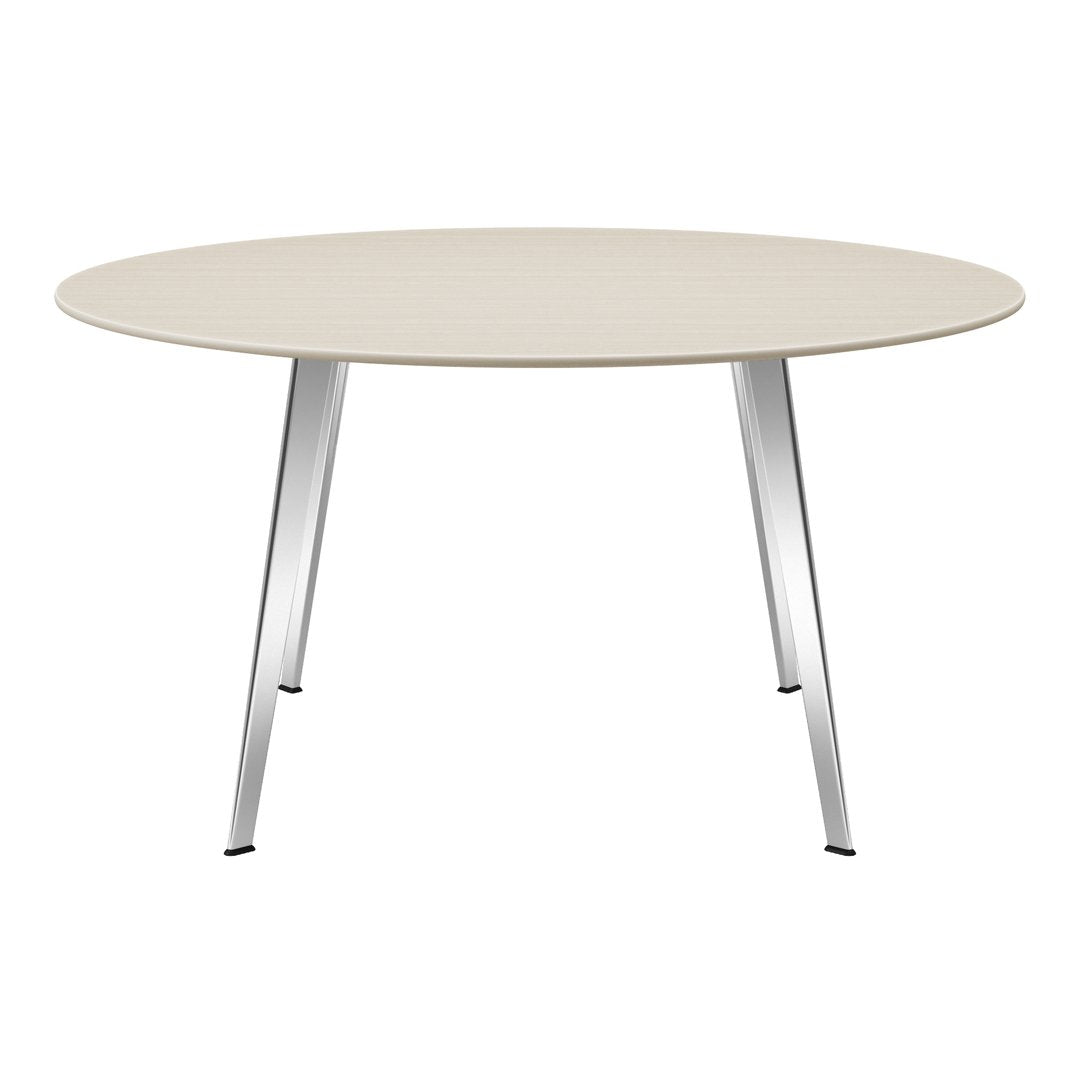 Round beige tabletop with light wood grain pattern and sleek silver legs. Modern design for contemporary spaces.