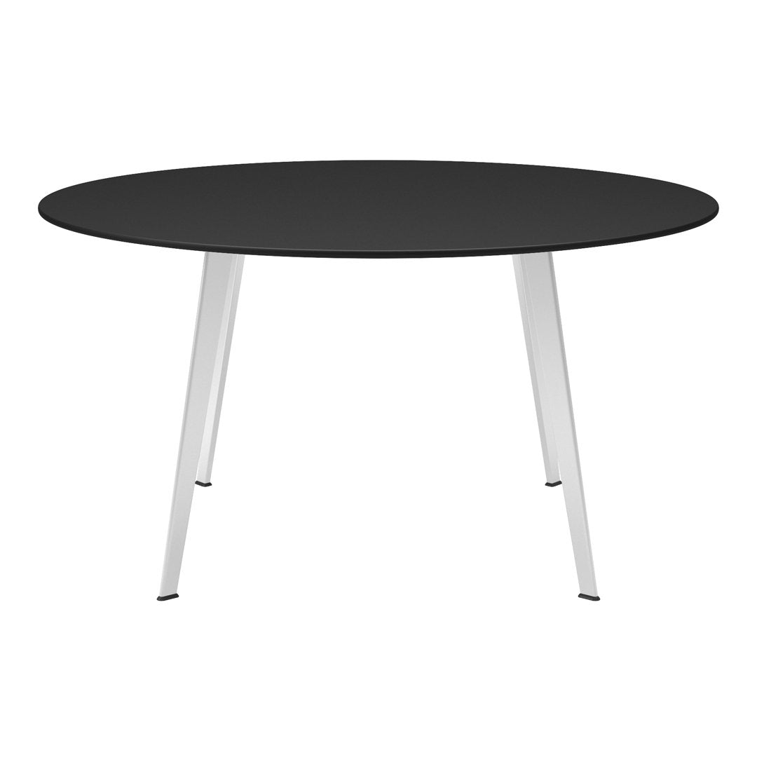 Round black tabletop with sleek silver legs, modern design suitable for contemporary spaces.