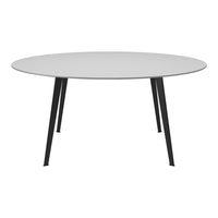 Round table with a sleek white top and black metal legs, featuring a modern minimalist design.