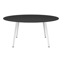 Round black table with sleek white legs, perfect for modern decor. Minimalist design adds elegance to any space.