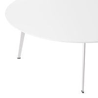 Round coffee table in sleek white finish with minimalist design and slender black-tipped legs.
