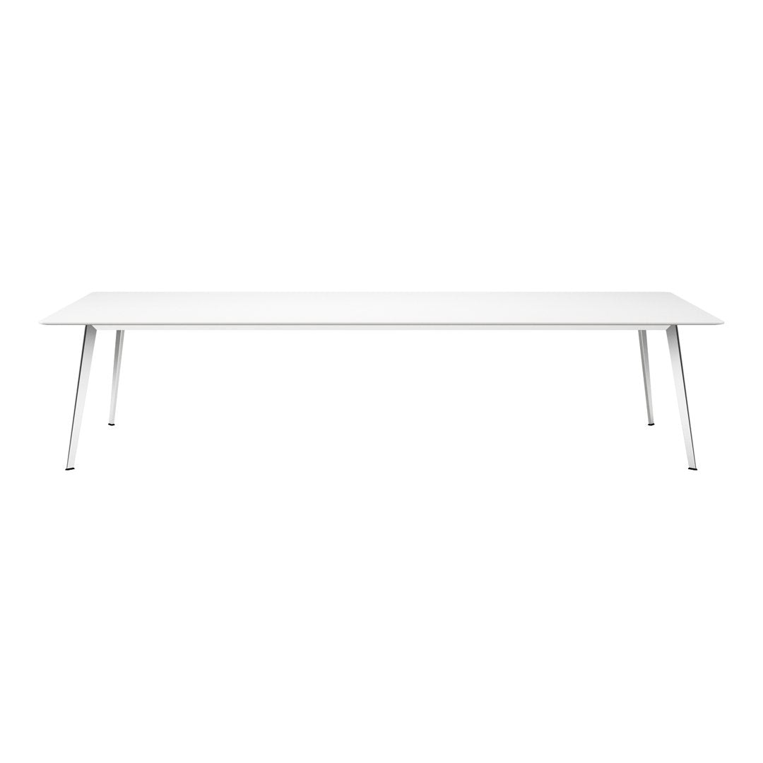 Modern white dining table with sleek silver legs, featuring a minimalist design and smooth, clean surface.