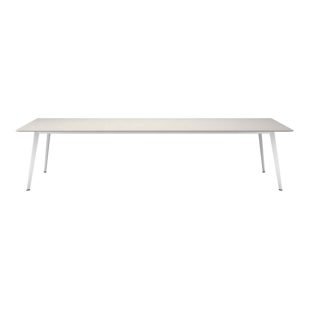 Modern white dining table with a smooth, minimalist design and sleek silver legs, perfect for contemporary spaces.