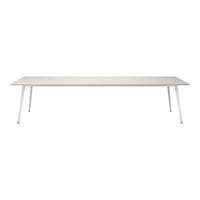 Modern white dining table with a smooth, minimalist design and sleek silver legs, perfect for contemporary spaces.