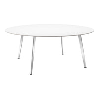 Round white table with sleek silver legs, minimalist design and smooth surface, perfect for modern interiors.