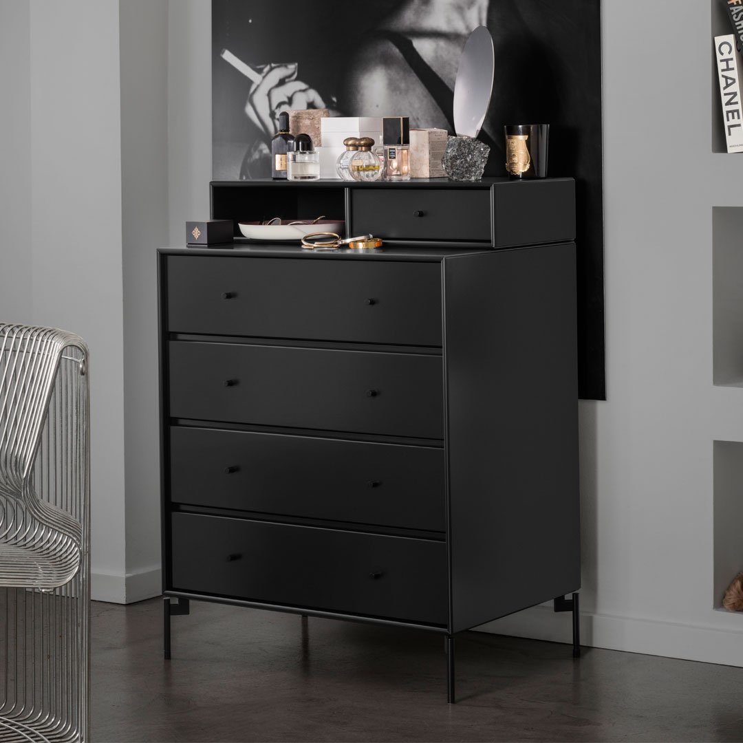 Modern black dresser with matte finish, sleek design, and minimalist patterns, enhancing contemporary decor.