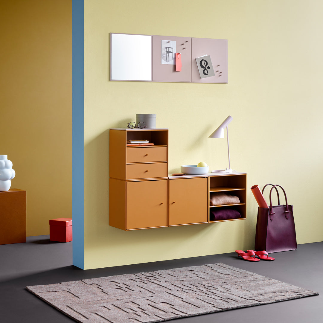 "Modern furniture in warm orange and burgundy with yellow walls and a textured gray rug, featuring geometric patterns."