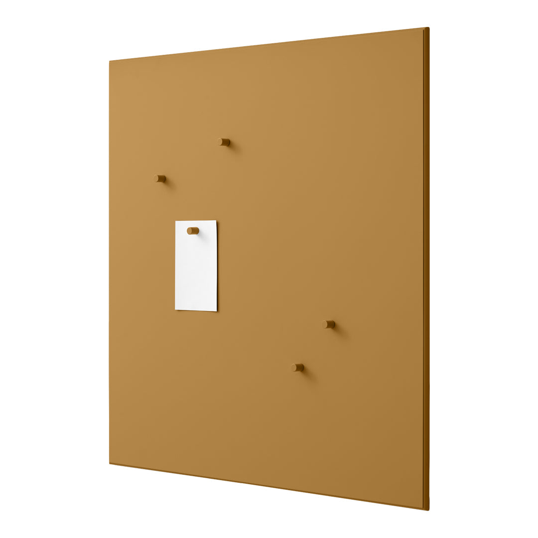 Brown wall panel with a smooth matte finish, featuring four evenly spaced knobs and a white paper note holder.