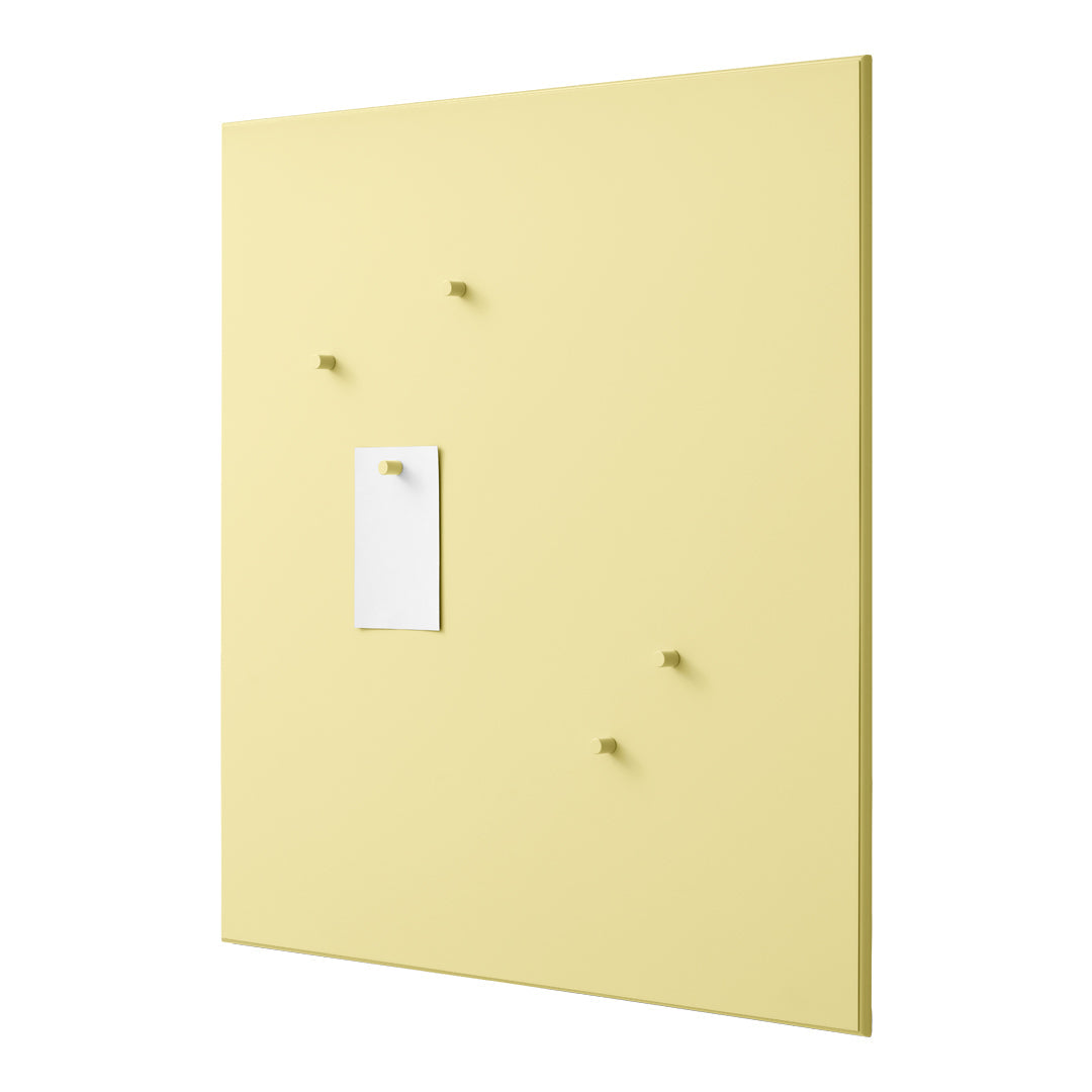 Yellow wall board with four small hooks and a white note holder, showcasing a smooth, solid color design.