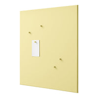 Yellow wall board with four small hooks and a white note holder, showcasing a smooth, solid color design.
