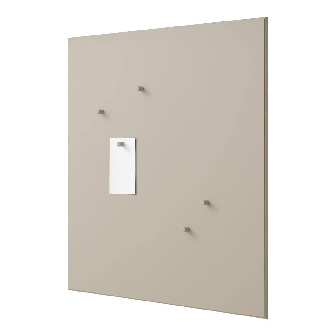 Beige wall panel with subtle texture, featuring white paper and small, coordinating hooks. Modern and minimalist design.