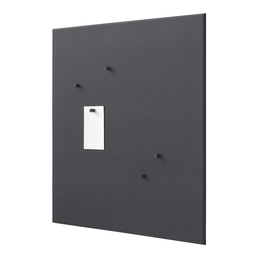 Black wall panel with small black hooks and a white note holder, featuring a sleek and minimalist design.