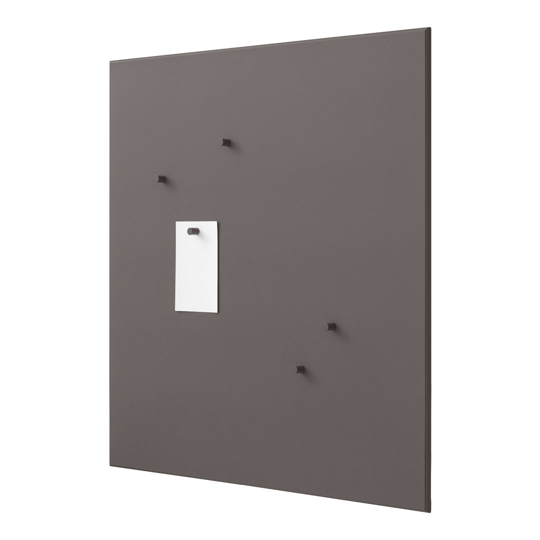 Gray wall panel with minimalist white note holder and dark gray hooks. Sleek and modern design.