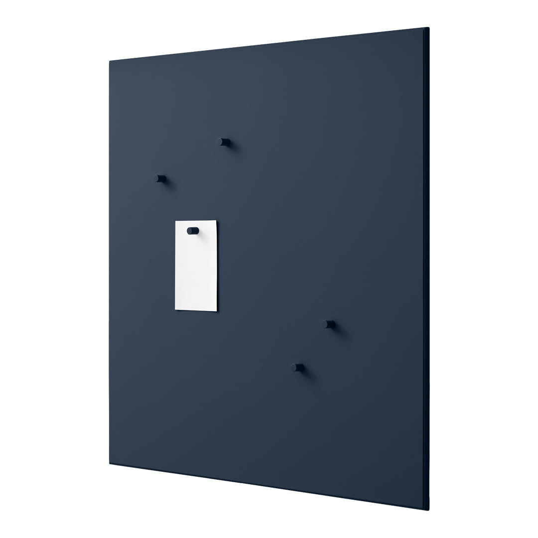 Navy blue wall board with white tag and four matching hooks for a modern, minimalist design.
