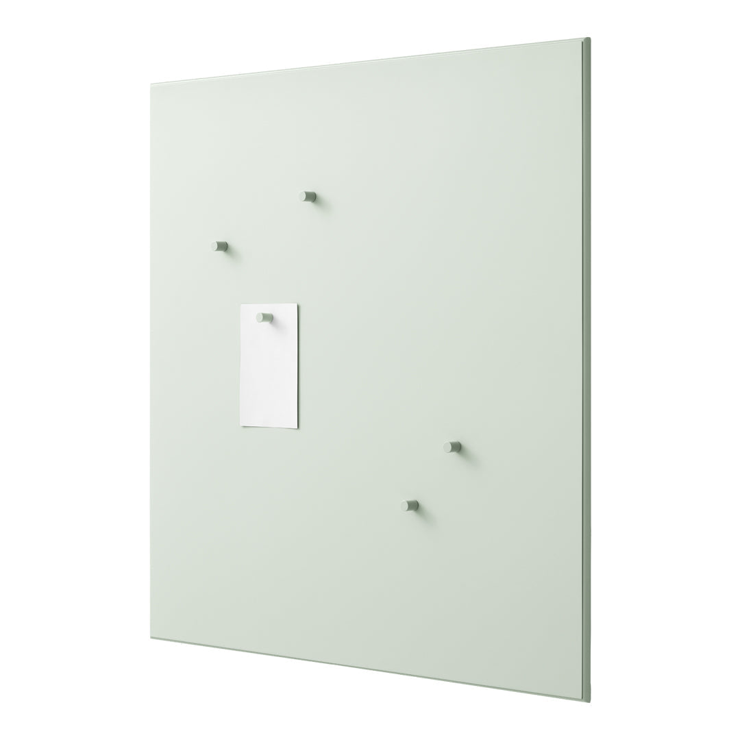 Mint green wall panel with minimalist white note holder and matching matte hooks, perfect for modern decor.