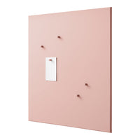 Pink wall panel with five matching hooks and a white note holder in simplistic, modern design.