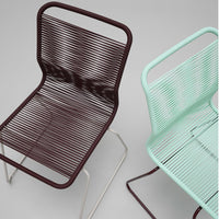 Two stylish chairs featuring dark purple and mint green striped patterns on a sleek metal frame.