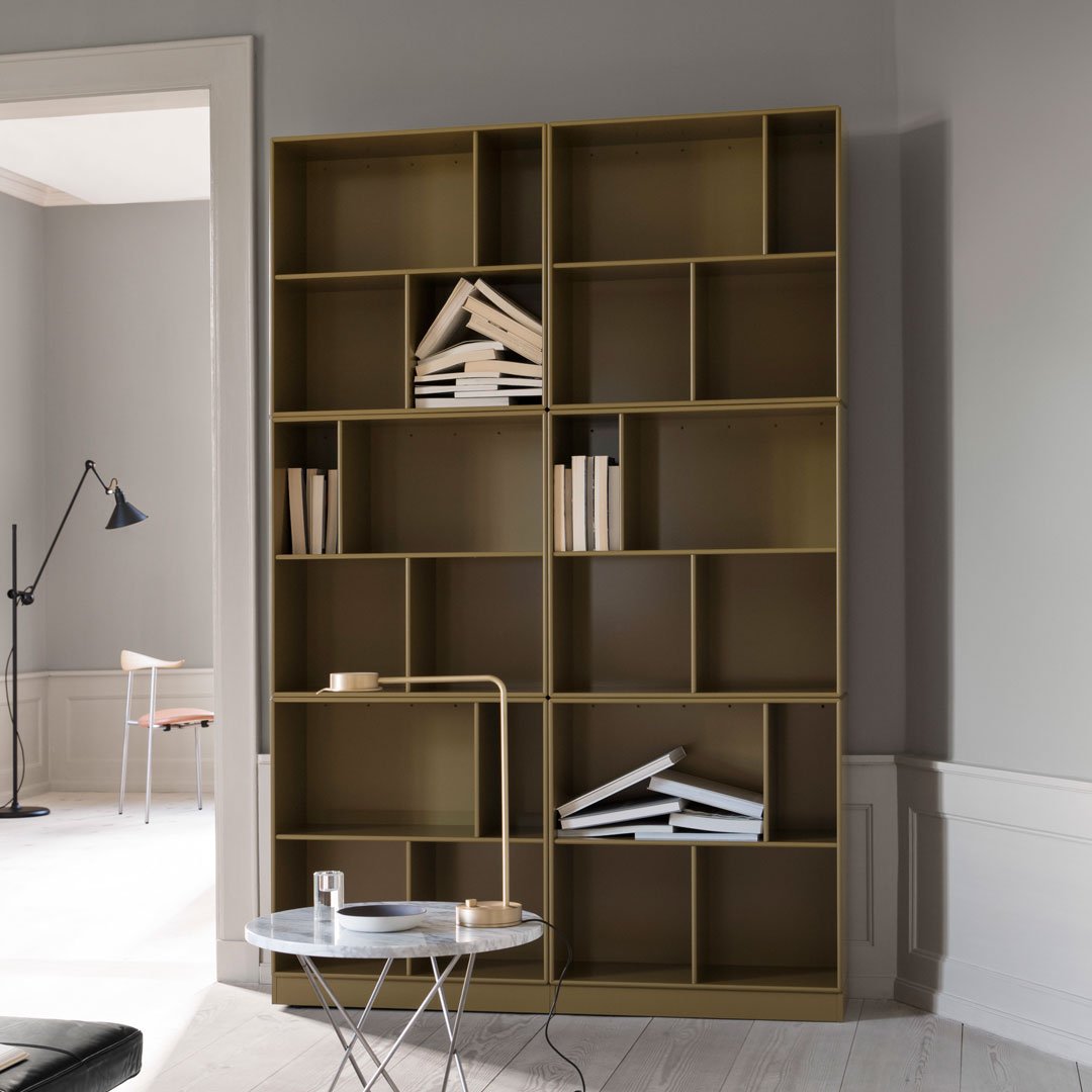 Modern olive green bookshelf with minimalist design, featuring contrasting white books against a neutral background.