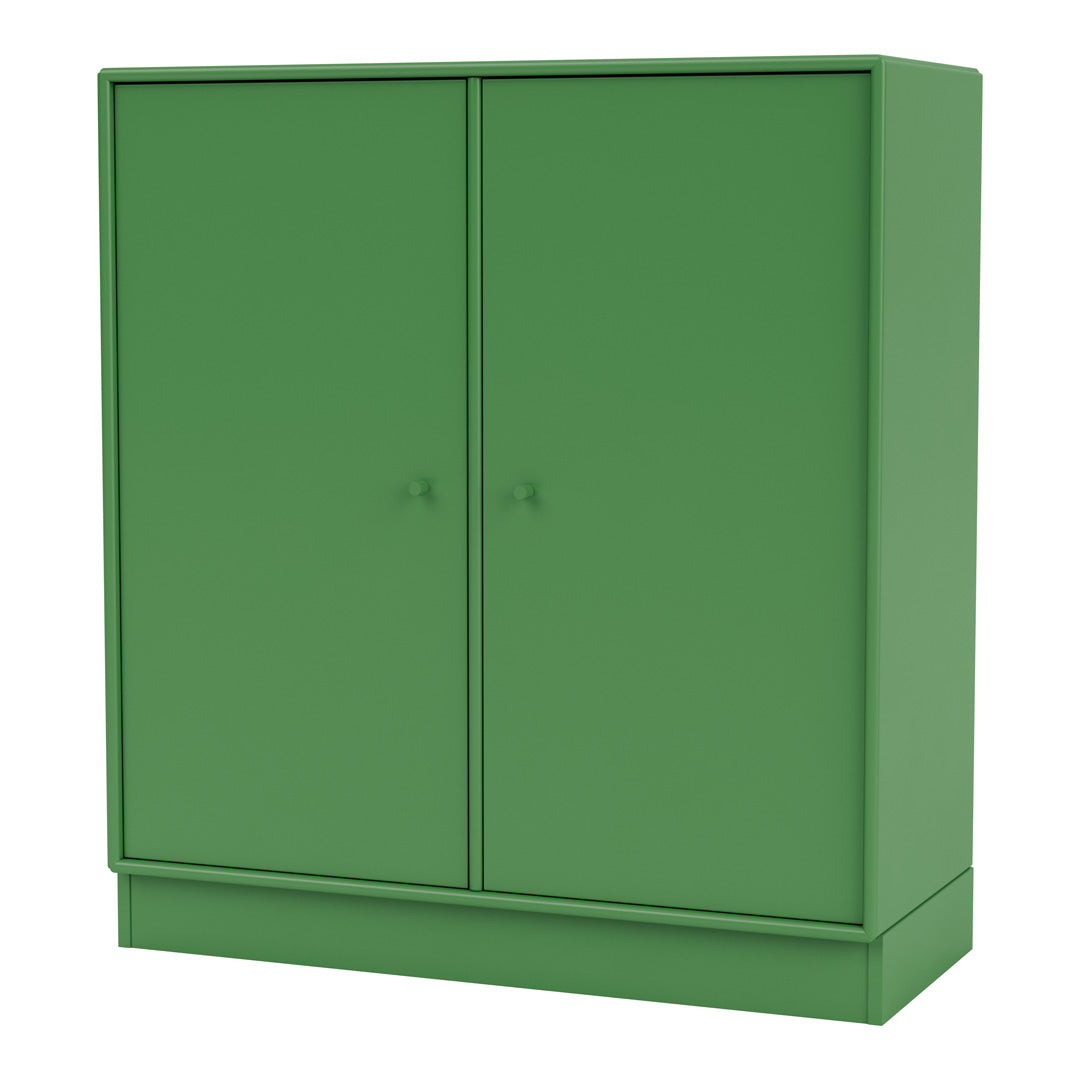 Green double-door storage cabinet with a sleek, modern design and smooth matte finish. Ideal for home or office decor.
