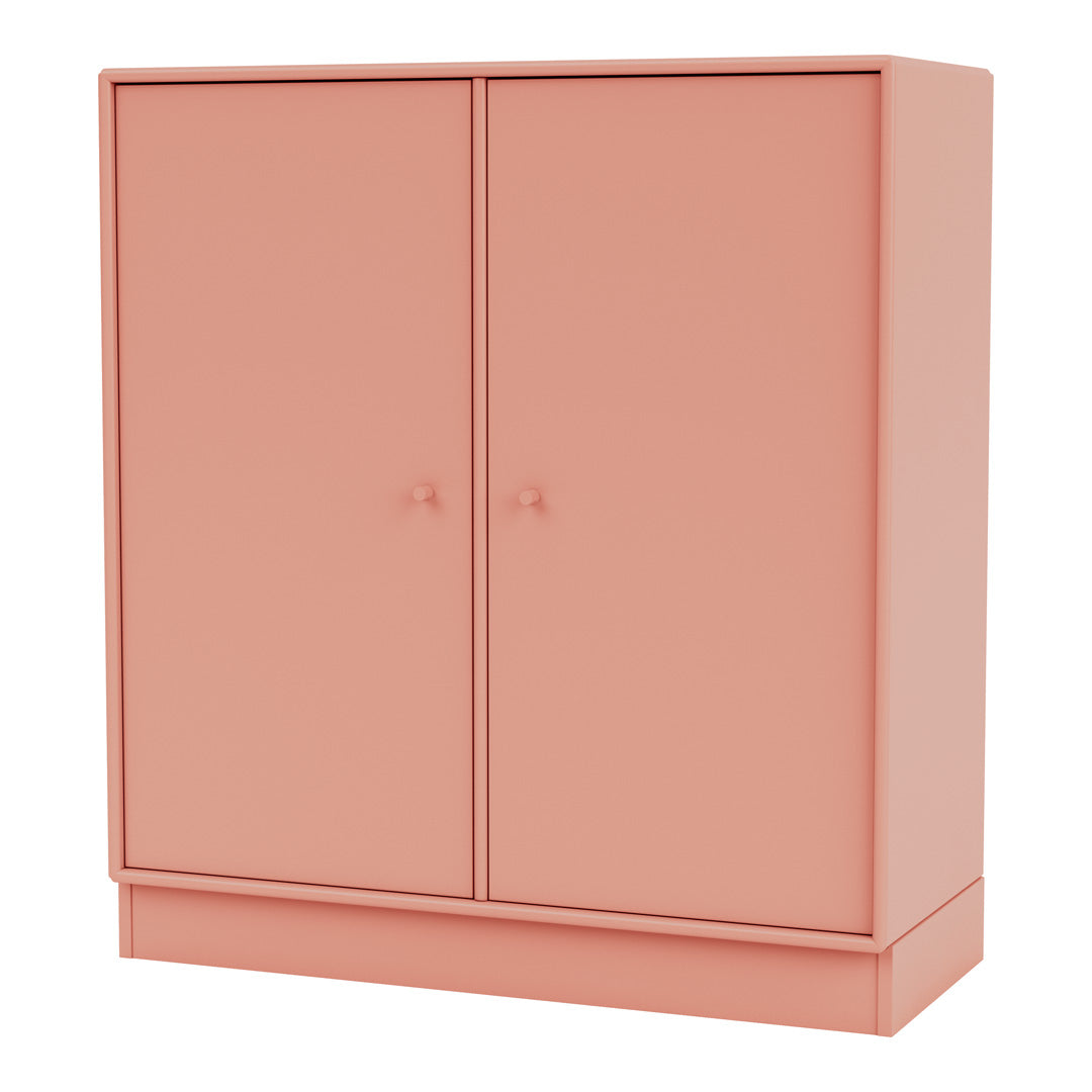 Blush pink cabinet with smooth finish and minimalist design, featuring two doors and matching round knobs.
