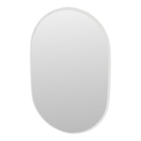 "Rounded mirror with a sleek white border, reflecting a clean, minimalist aesthetic."