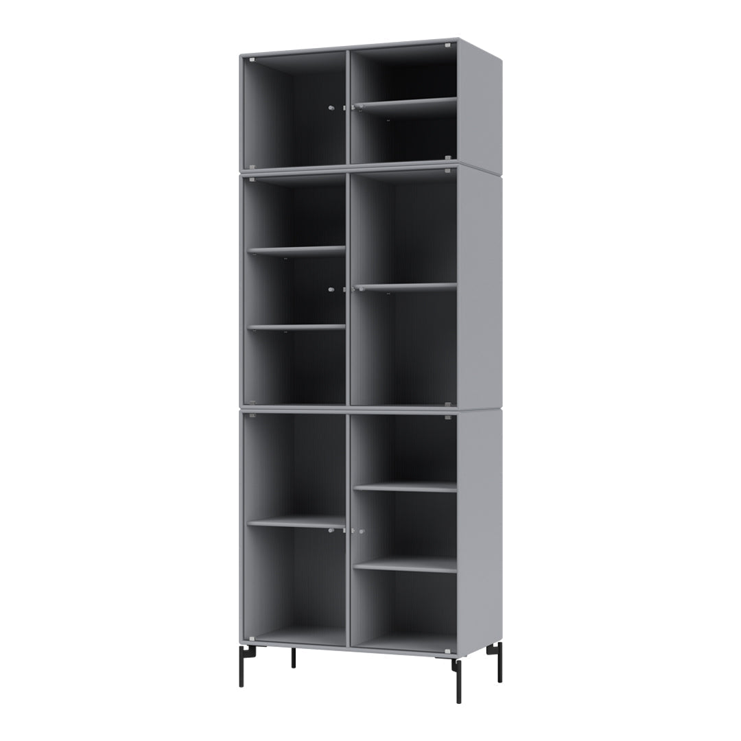 Tall gray bookshelf with multiple compartments and a sleek, minimalist design, featuring black metal legs.