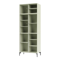 Tall shelving unit in soft green with vertical ribbed pattern and sleek black legs. Perfect for modern decor.