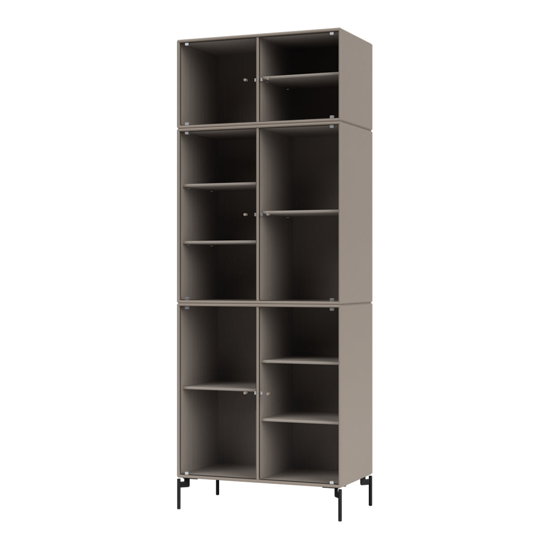 Tall modular bookshelf in soft taupe with vertical ribbed texture and black metal legs. Perfect for modern decor.