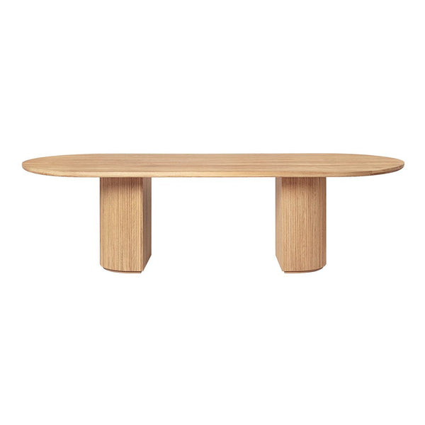 Light oak oval dining table with a smooth finish and minimalistic design. Two sturdy, rounded pedestal legs.