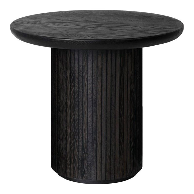 Round black table with a textured surface and vertical stripe pattern on the base, offering a sleek modern look.