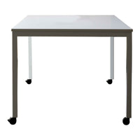 White tabletop with sleek gray legs and black wheels, featuring a minimalist design for modern spaces.