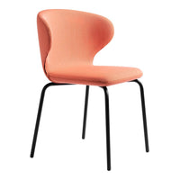 Peach-colored chair with a smooth, curved design and black metal legs. Modern and minimalistic style.