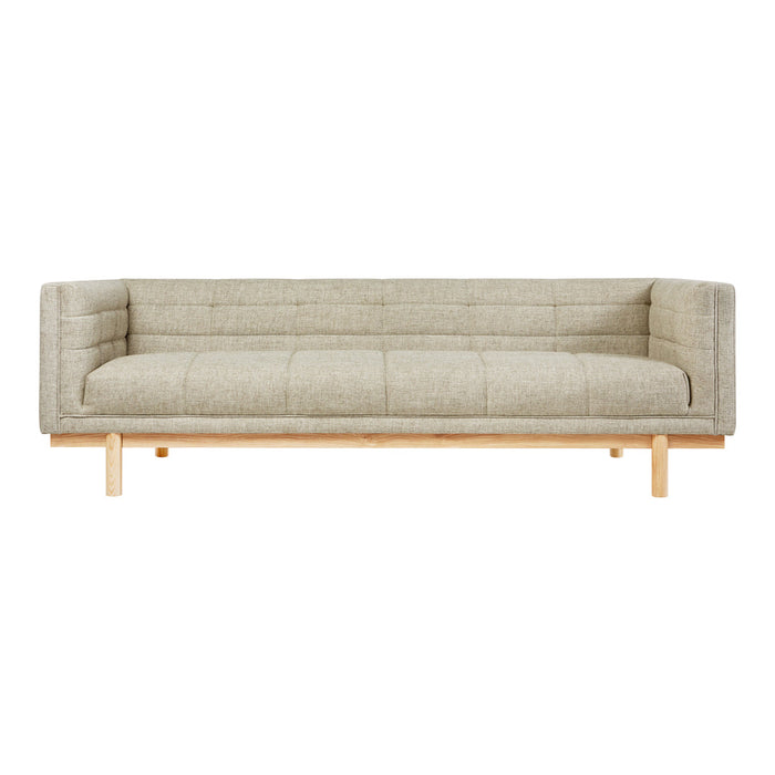 Beige upholstered sofa with a minimalist design and wood legs, featuring a quilted pattern for added texture.