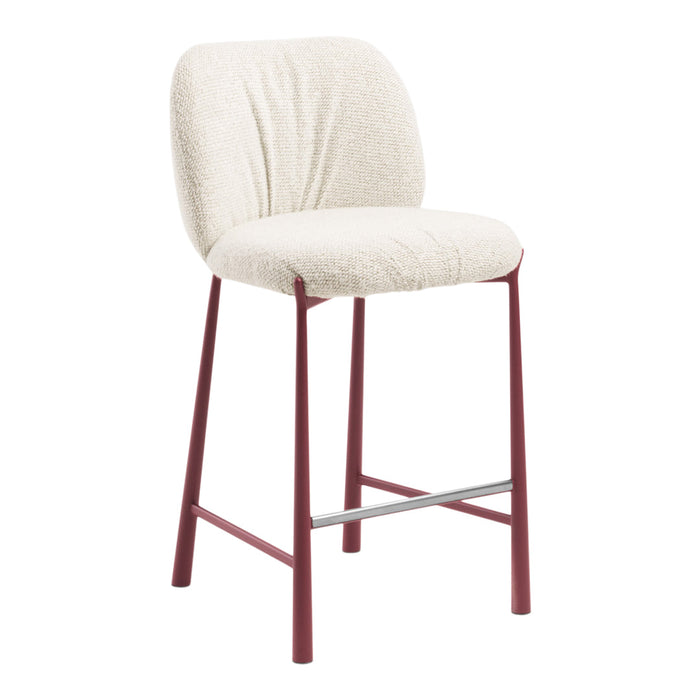 Cream upholstered bar stool with textured fabric and deep red metal legs. Stylish and modern design for any space.