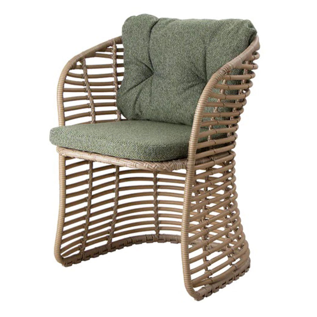 Green cushioned chair with natural woven pattern in a light brown frame. Perfect for modern and outdoor decor.