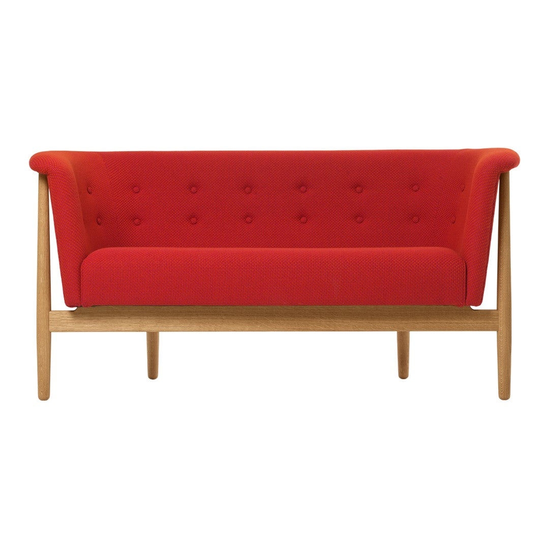 Red upholstered two-seater sofa with button detailing and natural wood legs. Modern design for stylish interiors.
