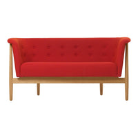 Red upholstered two-seater sofa with button detailing and natural wood legs. Modern design for stylish interiors.
