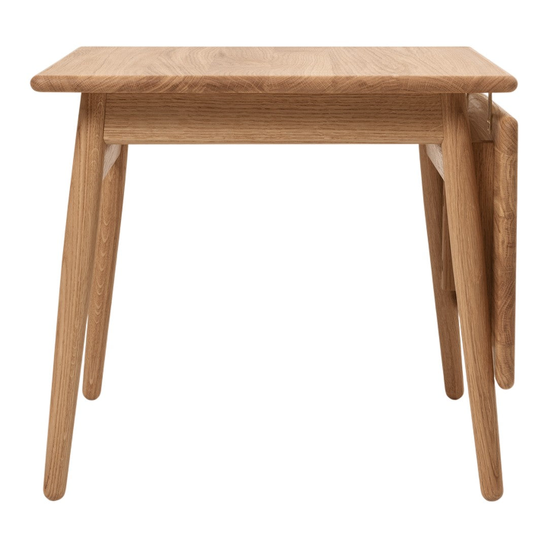 Light oak wood side table with a smooth finish and minimalist design. Ideal for modern interiors.