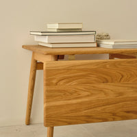 Natural oak finish with smooth grain pattern, complemented by a minimalist design and neutral backdrop.