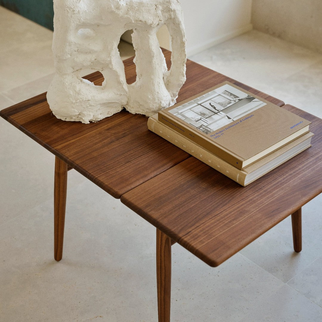 Stylish wooden coffee table with rich walnut finish, showcasing a sleek design and elegant natural grain patterns.