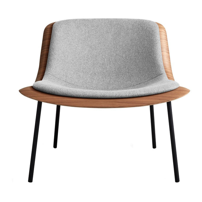Gray upholstered chair with a smooth wooden backrest and black metal legs, featuring a minimalist design.