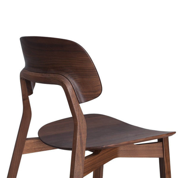 Sleek dark wood chair with smooth curves and a rich walnut finish, showcasing modern design elegance.