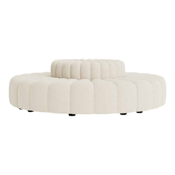 Cream-colored round ottoman with textured, tufted design and soft, scalloped edges. Ideal for modern decor.